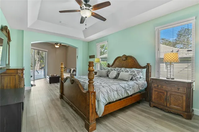 a spacious bedroom with a bed and dresser