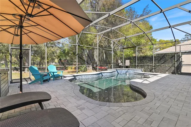 a view of a swimming pool with a lounge chair