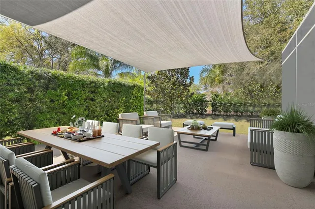 a view of a patio with table and chairs and potted plants