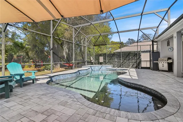 a view of a swimming pool with a patio