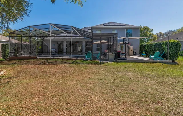 a view of a house with swimming pool and sitting area