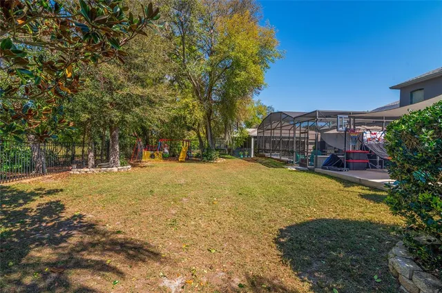 a swimming pool with trees in the background
