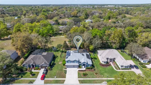 an aerial view of a house with garden space and street view