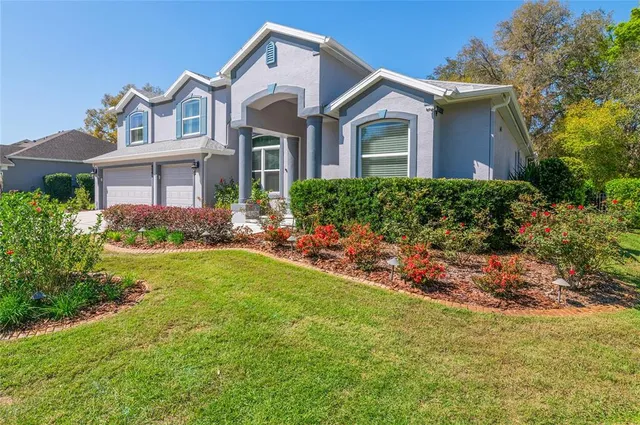 a front view of house with yard and green space