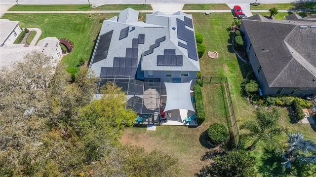 an aerial view of a house with a garden potted plants and large trees