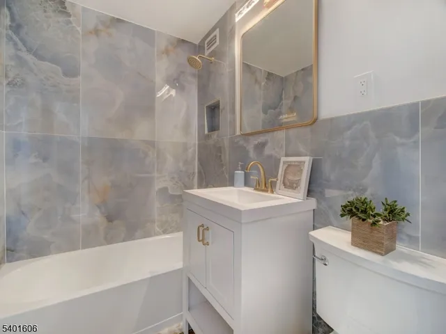 a bathroom with a sink a vanity and a bathtub
