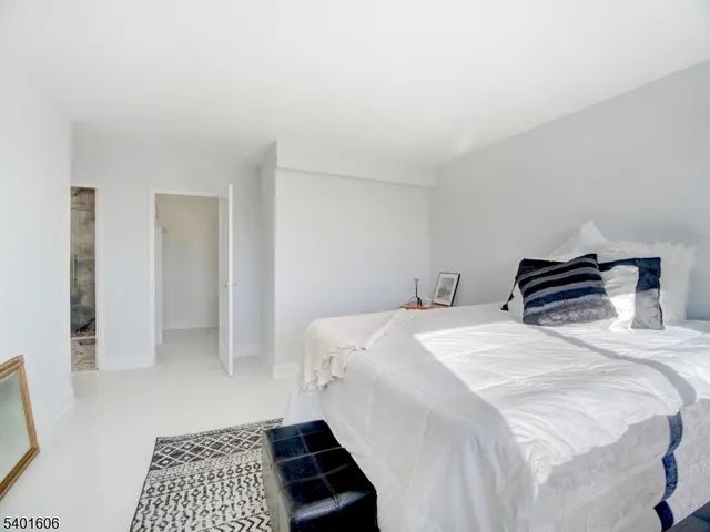 a bedroom with a bed and a rug