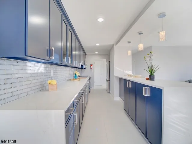 a kitchen with a refrigerator a stove and a cabinets