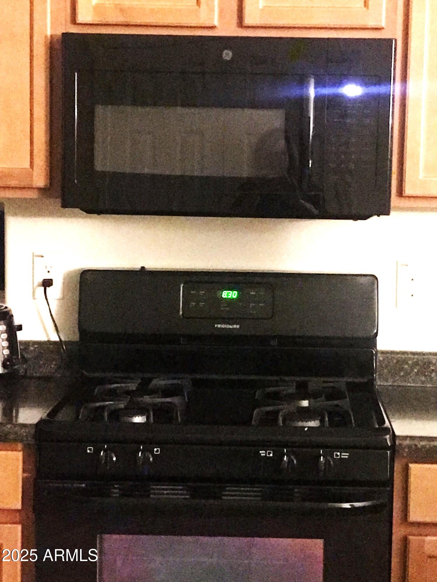 3931 East Narrowleaf Drive Gilbert, AZ 85298 - Photo 7 of 7 a kitchen with a stove and a microwave