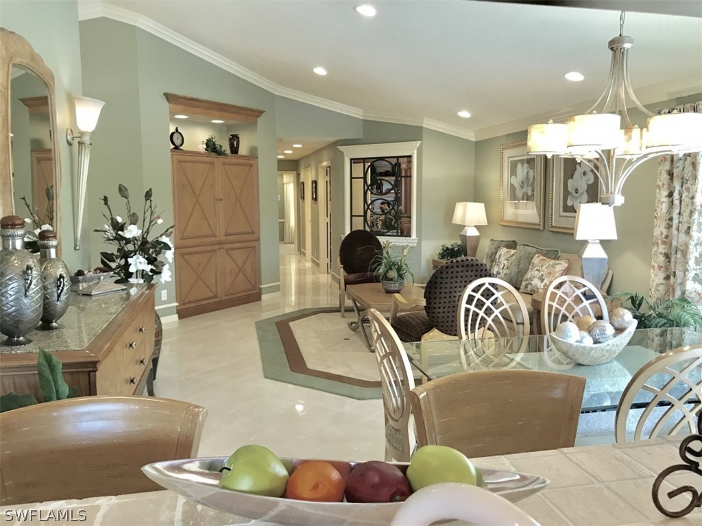 9324 Springview Loop Estero, FL 33928 - Photo 7 of 24 a living room with furniture potted plant and a chandelier