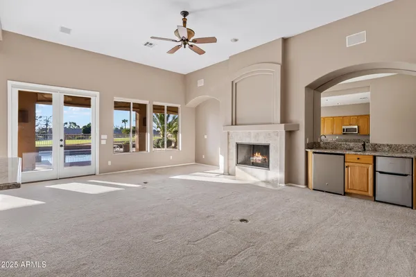 a living room with fireplace furniture and a large window