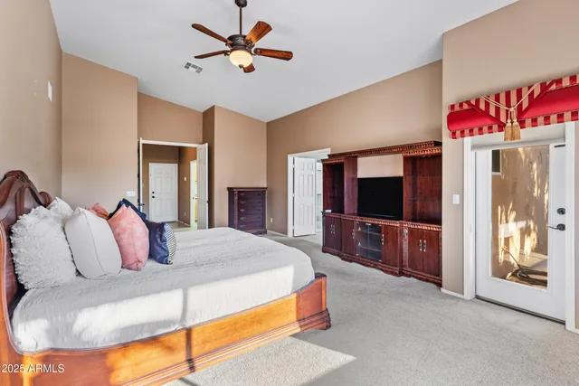 a view of a livingroom with a ceiling fan and window