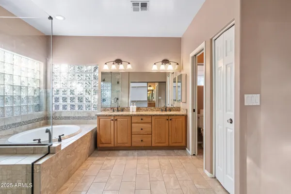 a large white kitchen with a large window