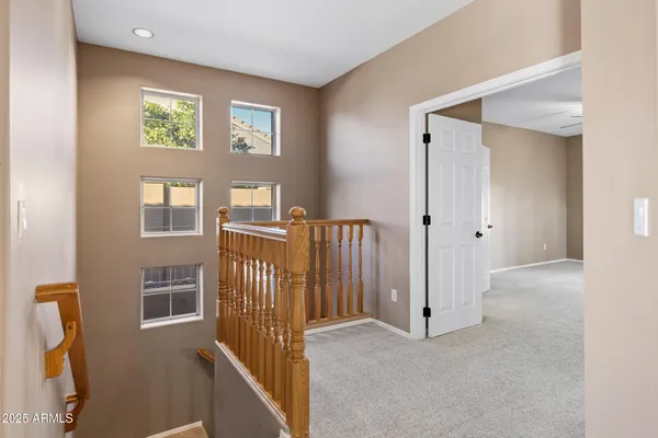 an empty room with closet and fan