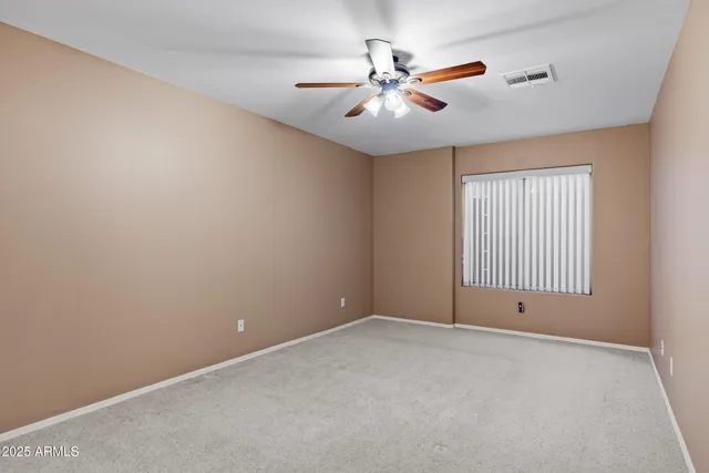 a view of a lake with a bench and floor to ceiling window