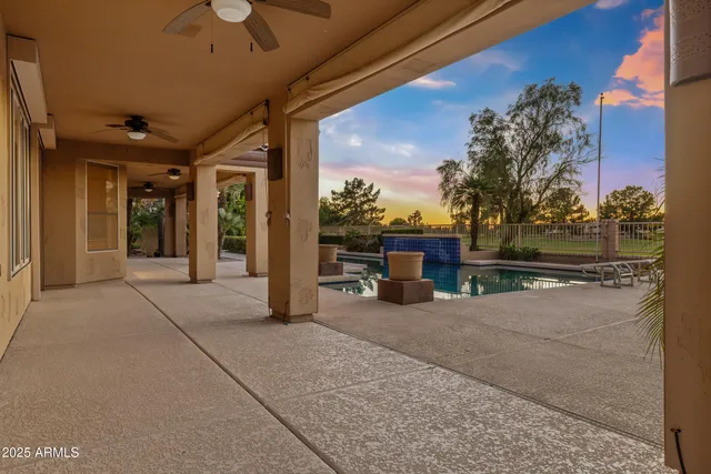 a view of a roof deck with table and chairs and potted plants
