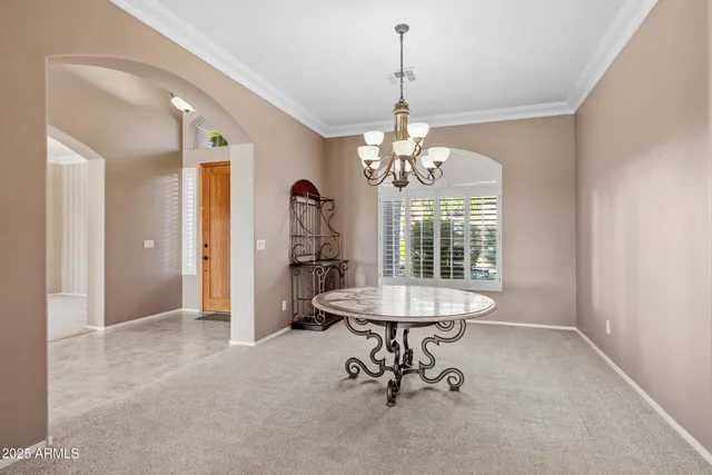a large white kitchen with kitchen island a large window a sink and stainless steel appliances