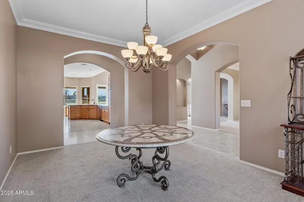 a large kitchen with granite countertop a sink a stove and cabinets