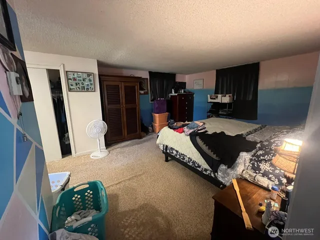 a room with a bed and a mirror