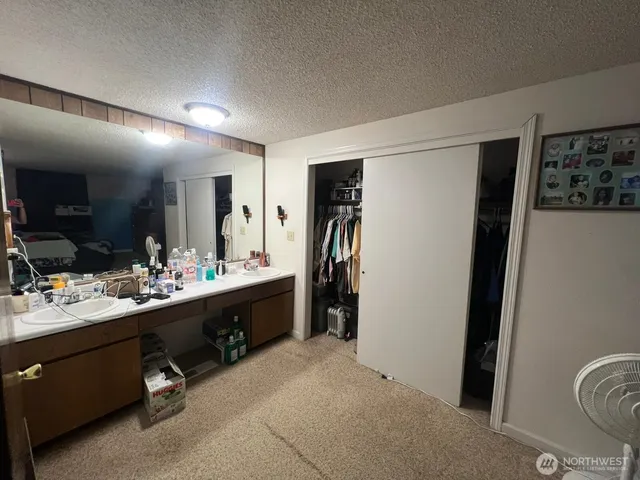 a bed sitting in a bedroom next to a window