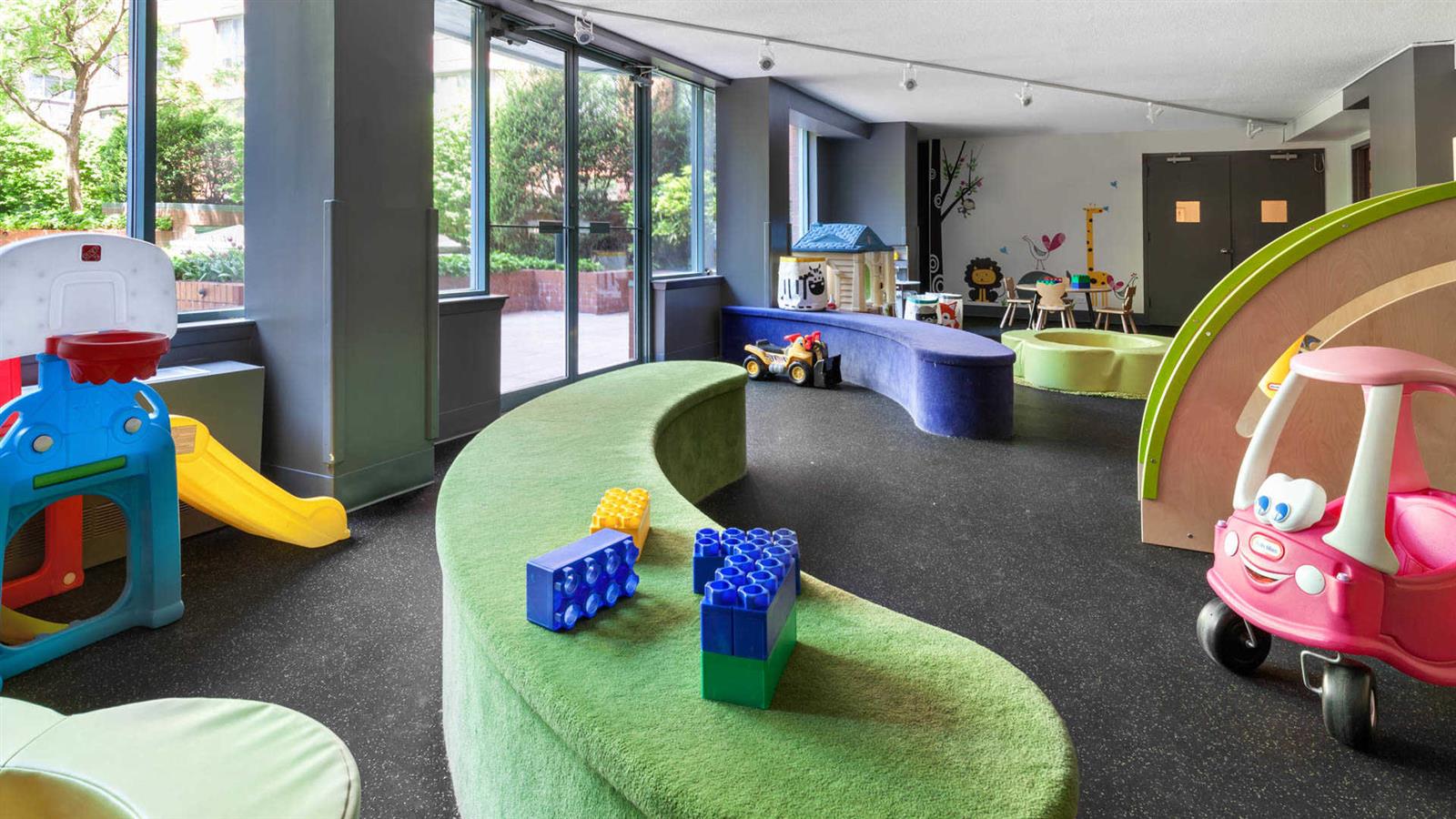 a living room with furniture and a floor to ceiling window