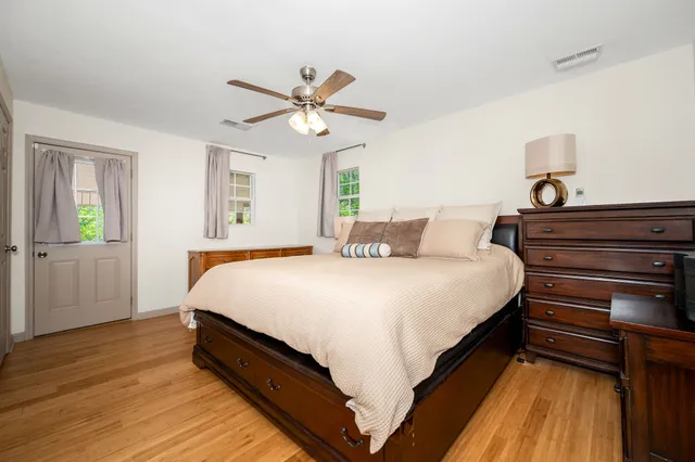 a bedroom with a bed and wooden floor