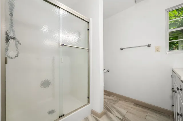 a bathroom with a glass shower door