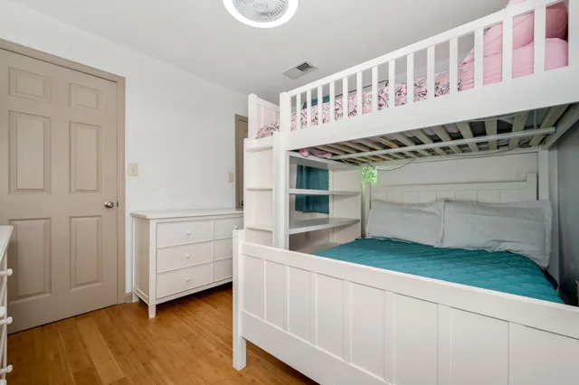 a kitchen with white cabinets and sink