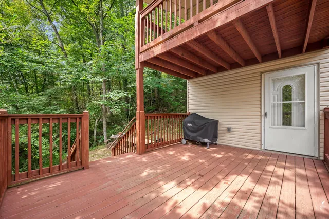 a view of a backyard with floor to ceiling window and wooden floor