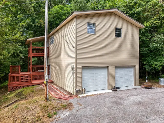 a view of a house with a yard and wooden fence