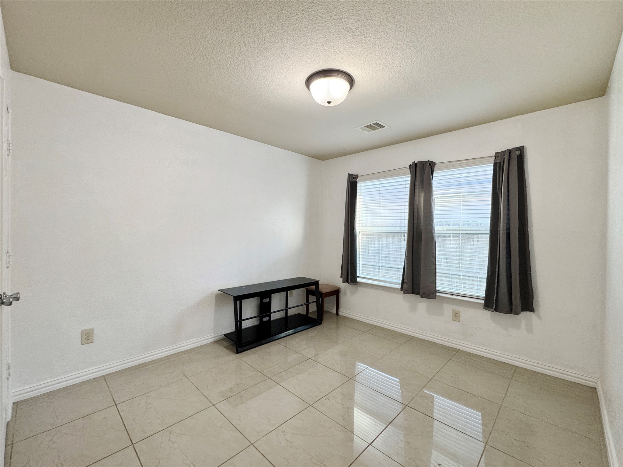 6614 Pine Tree Springs Houston, TX 77049 - Photo 11 of 14 a view of an empty room with windows