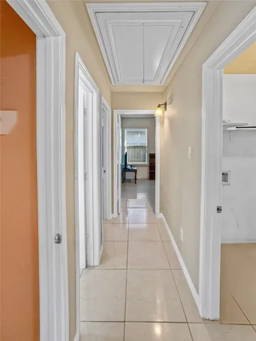 a view of a hallway with a livingroom and a bathroom