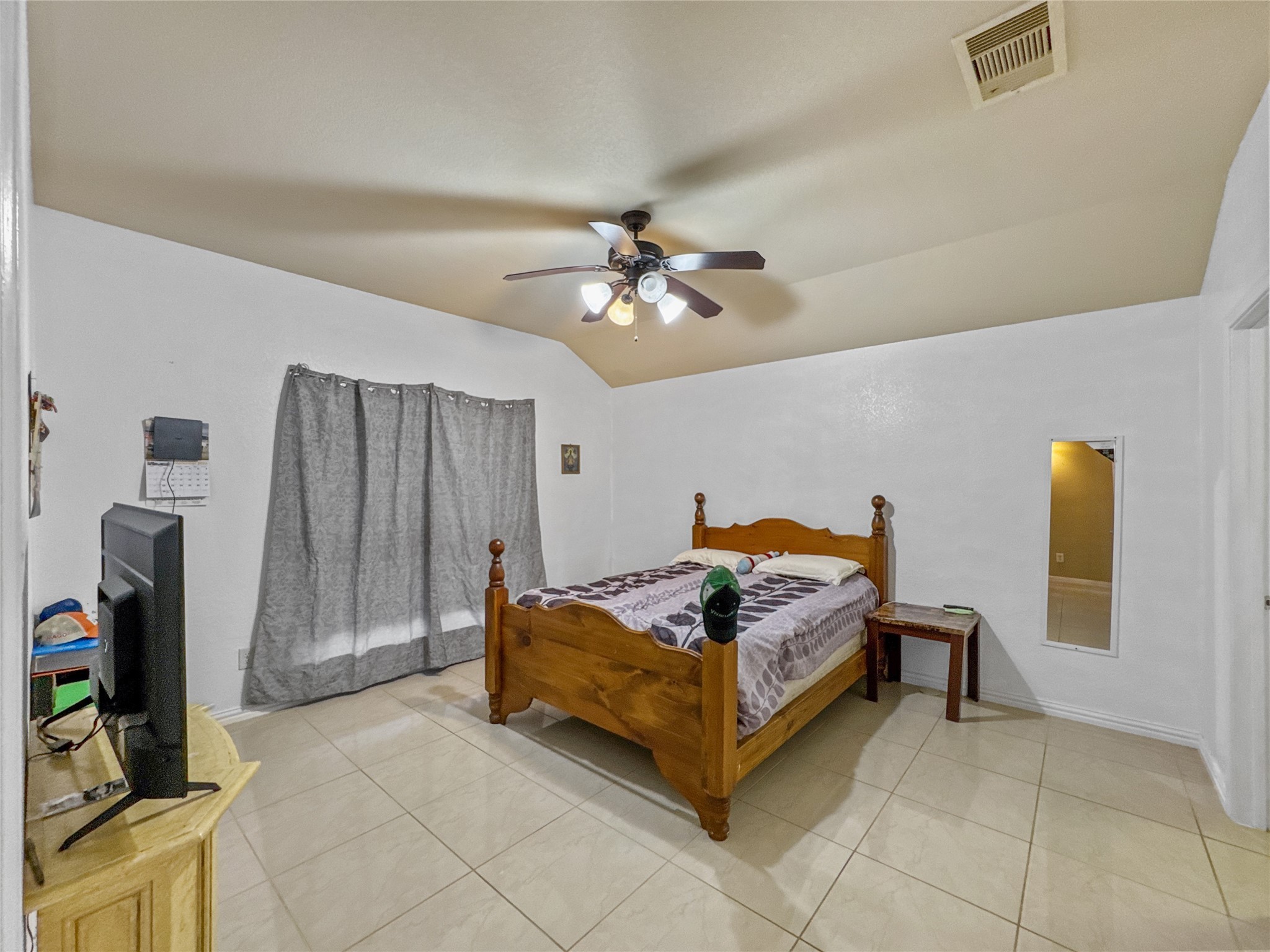 6614 Pine Tree Springs Houston, TX 77049 - Photo 6 of 14 a bedroom with a bed and a chandelier