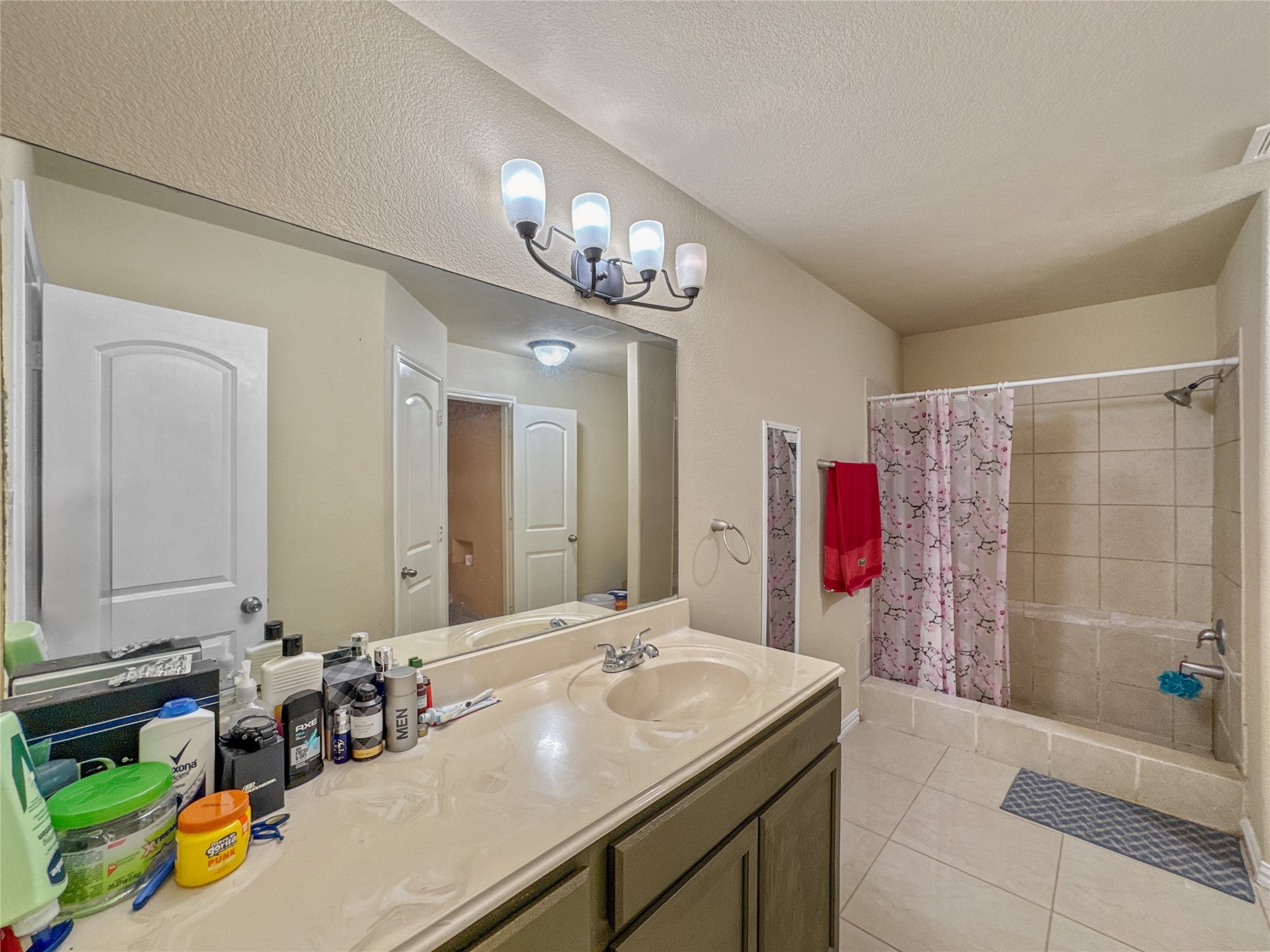 6614 Pine Tree Springs Houston, TX 77049 - Photo 7 of 14 a bathroom with a sink and a mirror