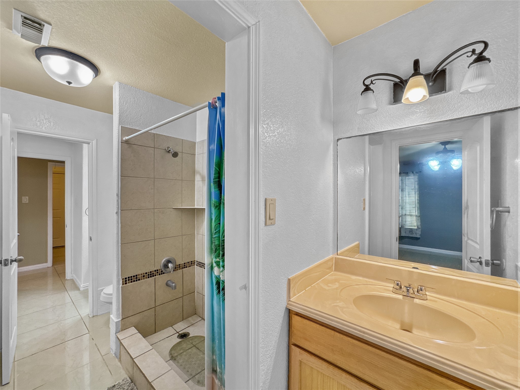 6614 Pine Tree Springs Houston, TX 77049 - Photo 9 of 14 a bathroom with a sink and a mirror