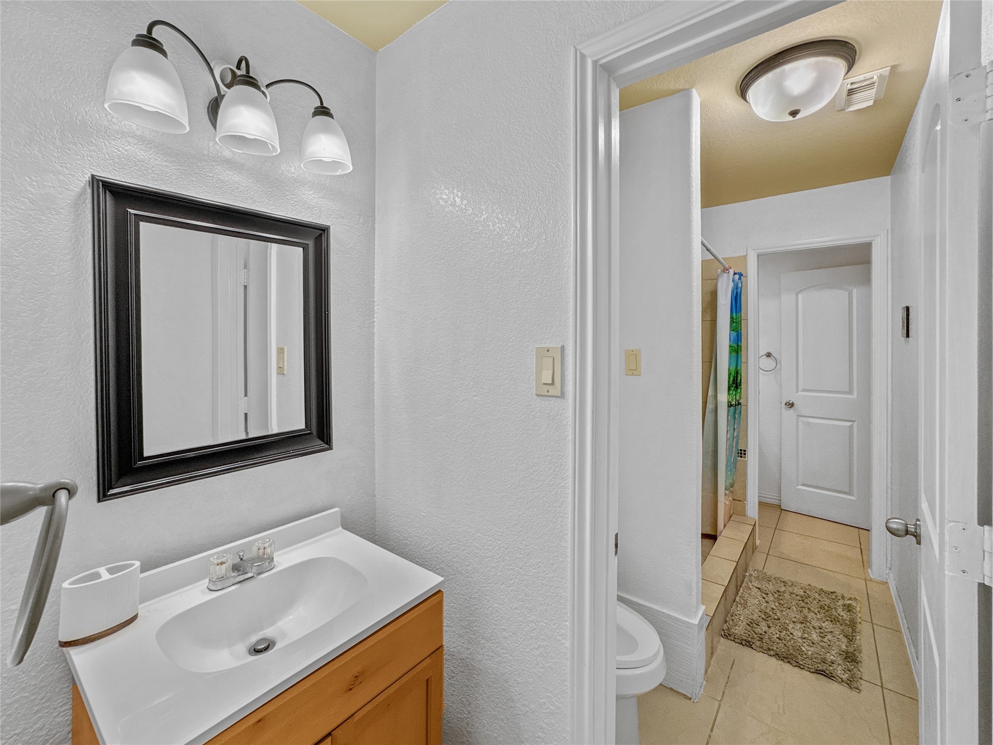6614 Pine Tree Springs Houston, TX 77049 - Photo 10 of 14 a bathroom with a sink and a mirror
