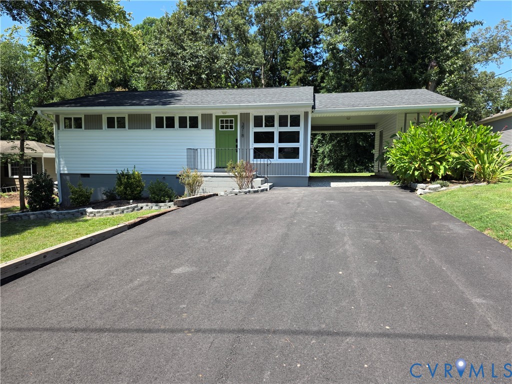 3918 Wood Dale Road Chester, VA 23831 - Photo 1 of 28 a front view of a house with a yard and garage