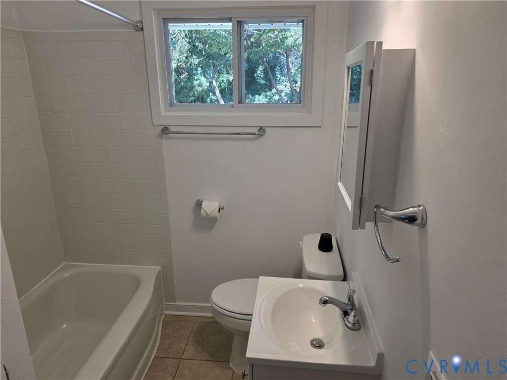 3918 Wood Dale Road Chester, VA 23831 - Photo 12 of 28 a bathroom with a sink a toilet and shower
