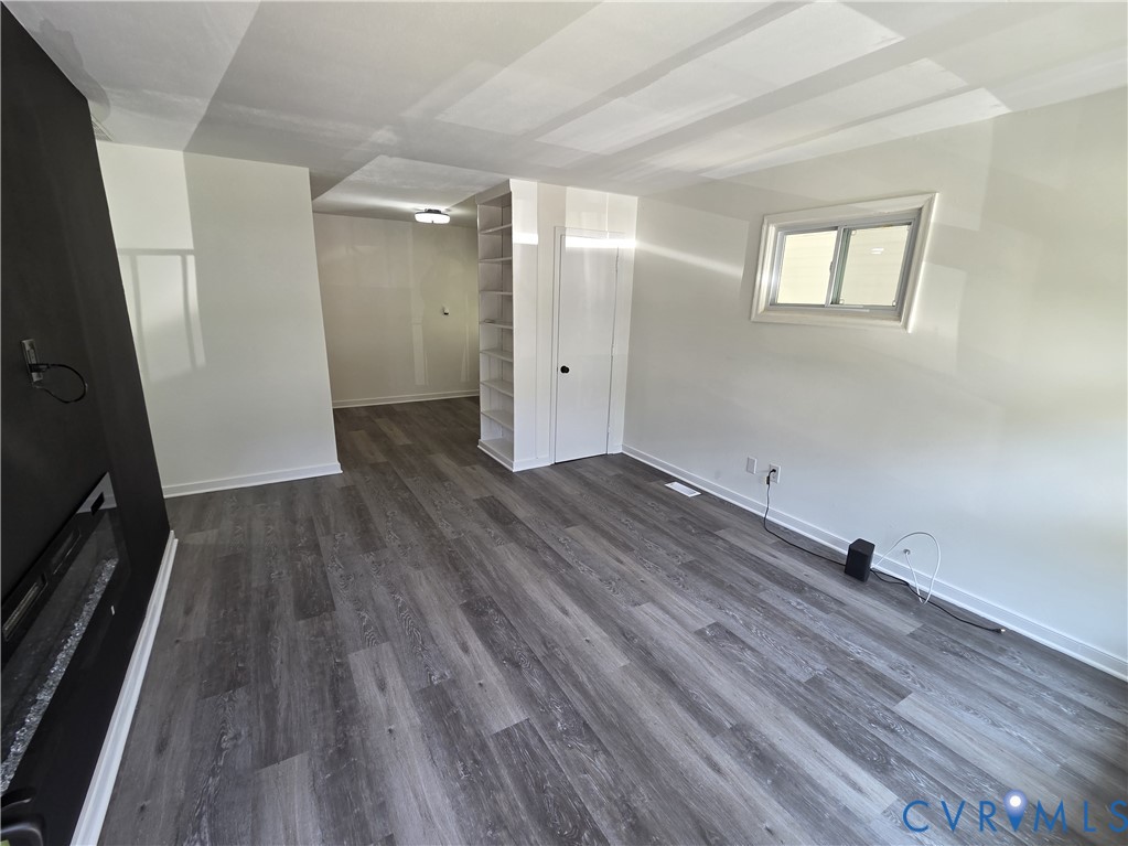 3918 Wood Dale Road Chester, VA 23831 - Photo 5 of 28 wooden floor in an empty room with a window