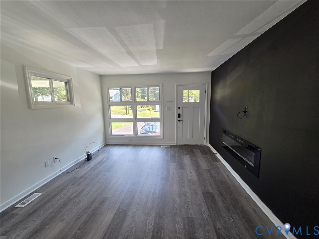 3918 Wood Dale Road Chester, VA 23831 - Photo 6 of 28 an empty room with wooden floor and windows