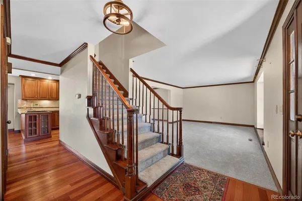 a view of entryway and hall with wooden floor
