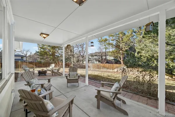 a view of a yard with plants and trees