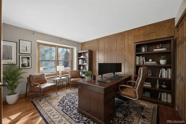 a workspace with furniture bookshelf and a window