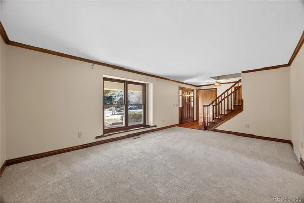 a view of an empty room with stairs