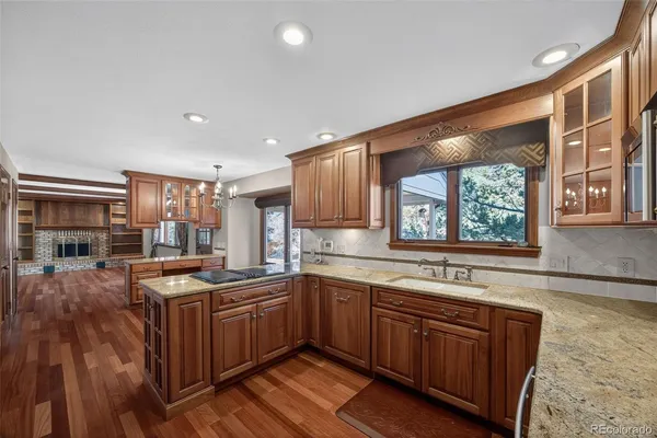a kitchen with granite countertop a stove sink and microwave