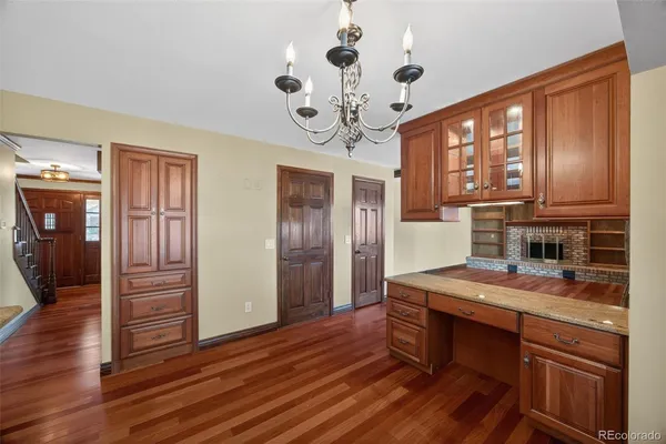a view of a kitchen with granite countertop a stove top oven