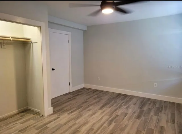 a view of a room with wooden floor