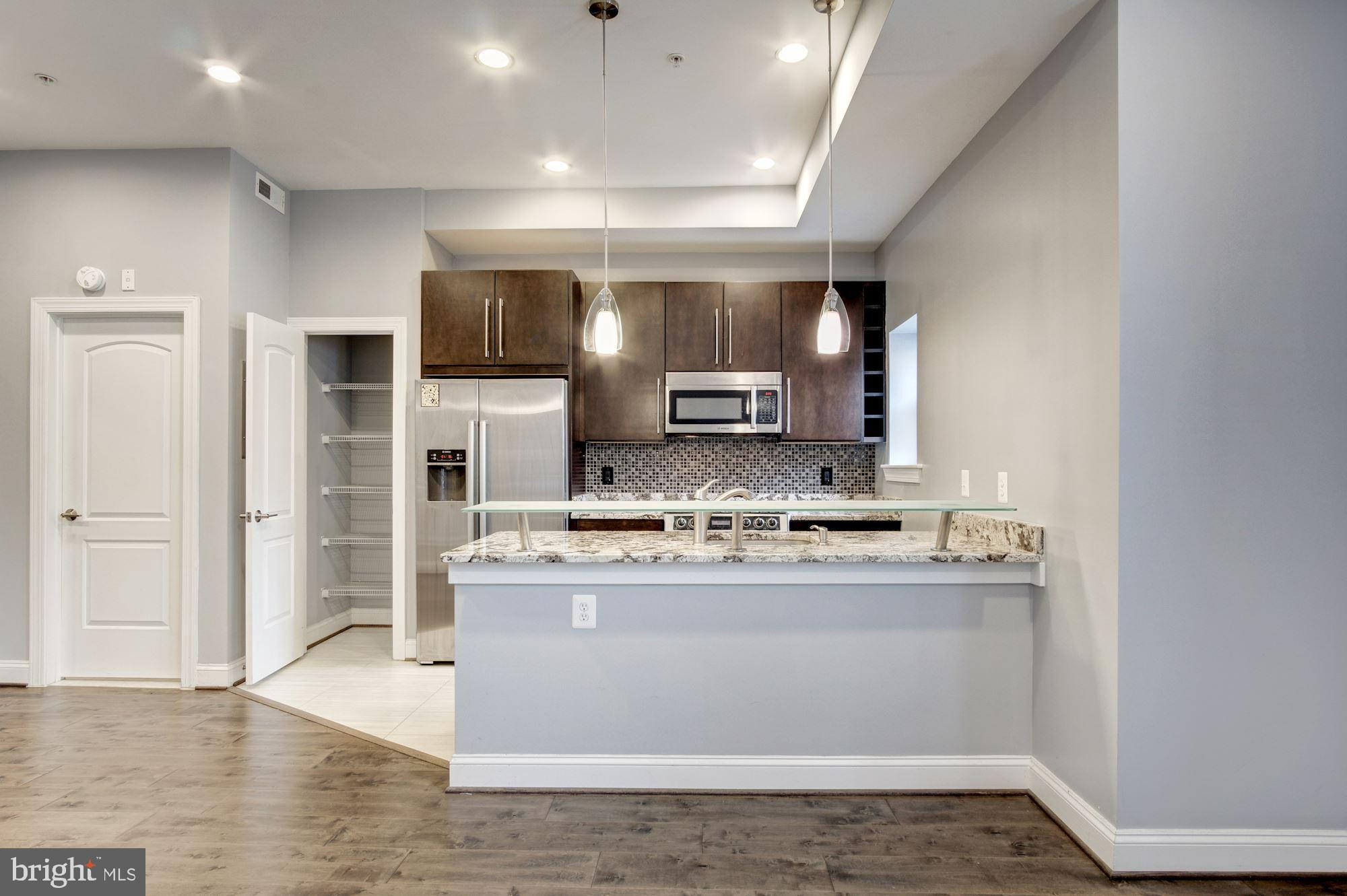 1333 Euclid Street Northwest, Unit 202 Washington, DC 20009 - Photo 3 of 14 a view of kitchen with cabinets microwave and refrigerator