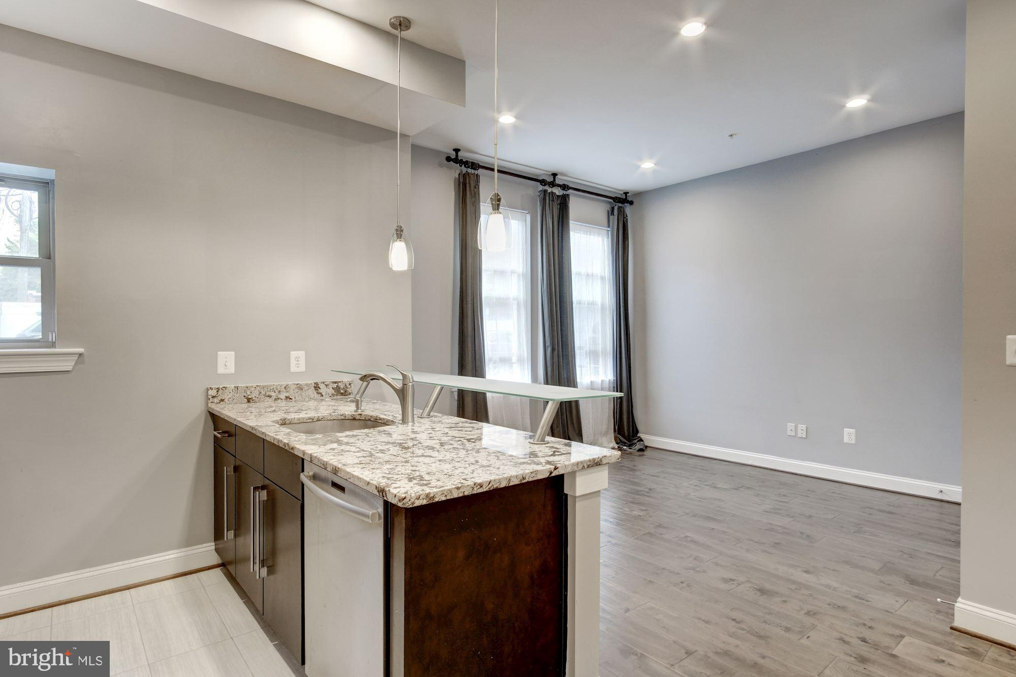 1333 Euclid Street Northwest, Unit 202 Washington, DC 20009 - Photo 6 of 14 a bathroom with a granite countertop sink and a mirror