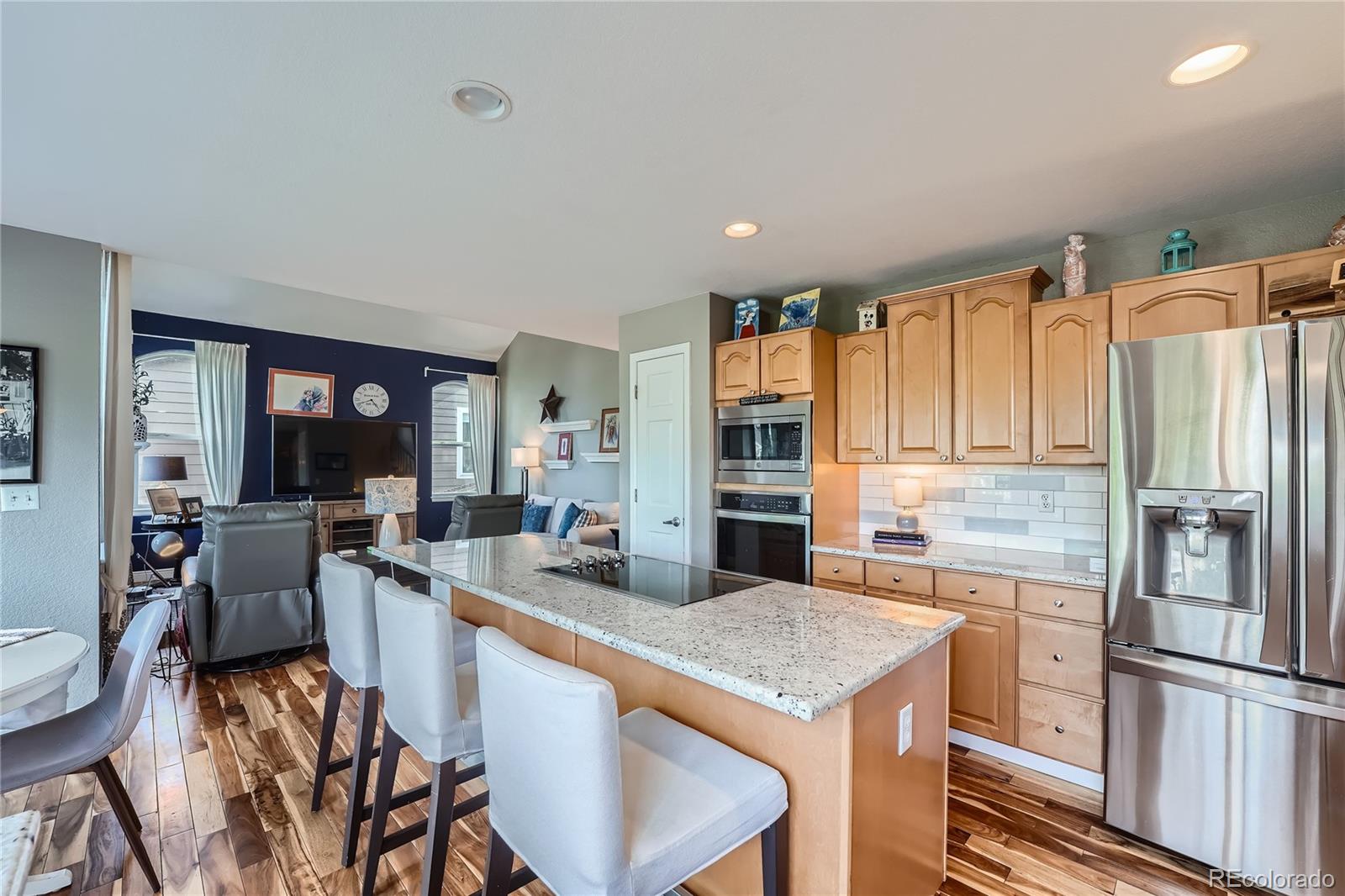 9538 La Quinta Drive Lone Tree, CO 80124 - Photo 11 of 41 a kitchen with granite countertop a refrigerator stove top oven dining table and chairs